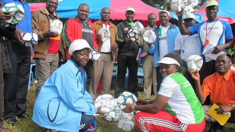 30 balls being handed over to organising team