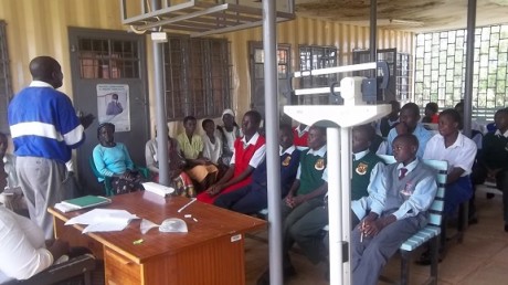 An Area Education Officer sharing with sponsored students and their guardians during the guardians meeting